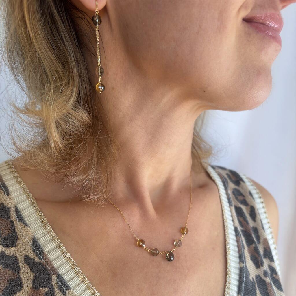 golden Citrine and Smoky Quartz gemstones on a 18k chain on a model with leopard print top