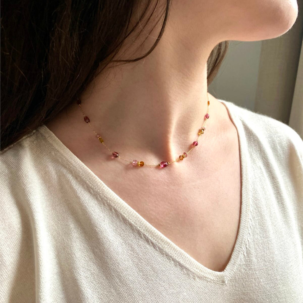 Pink and golden tourmaline beads choker necklace in 18k gold on a model's neck, limited edition by Perle de Lune