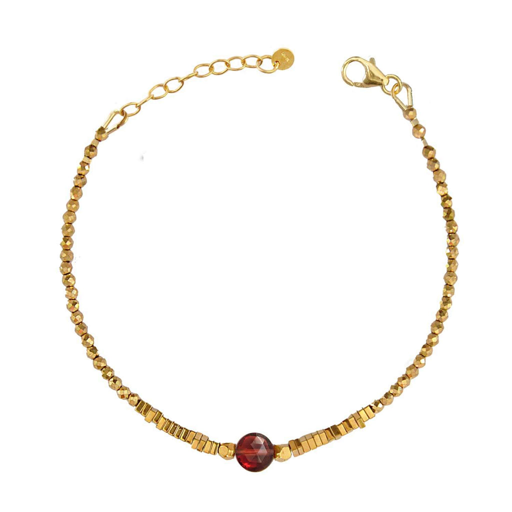 Elegant Hematite Beaded bracelet with a central faceted red garnet gemstone on a white background. Perle de Lune jewelry