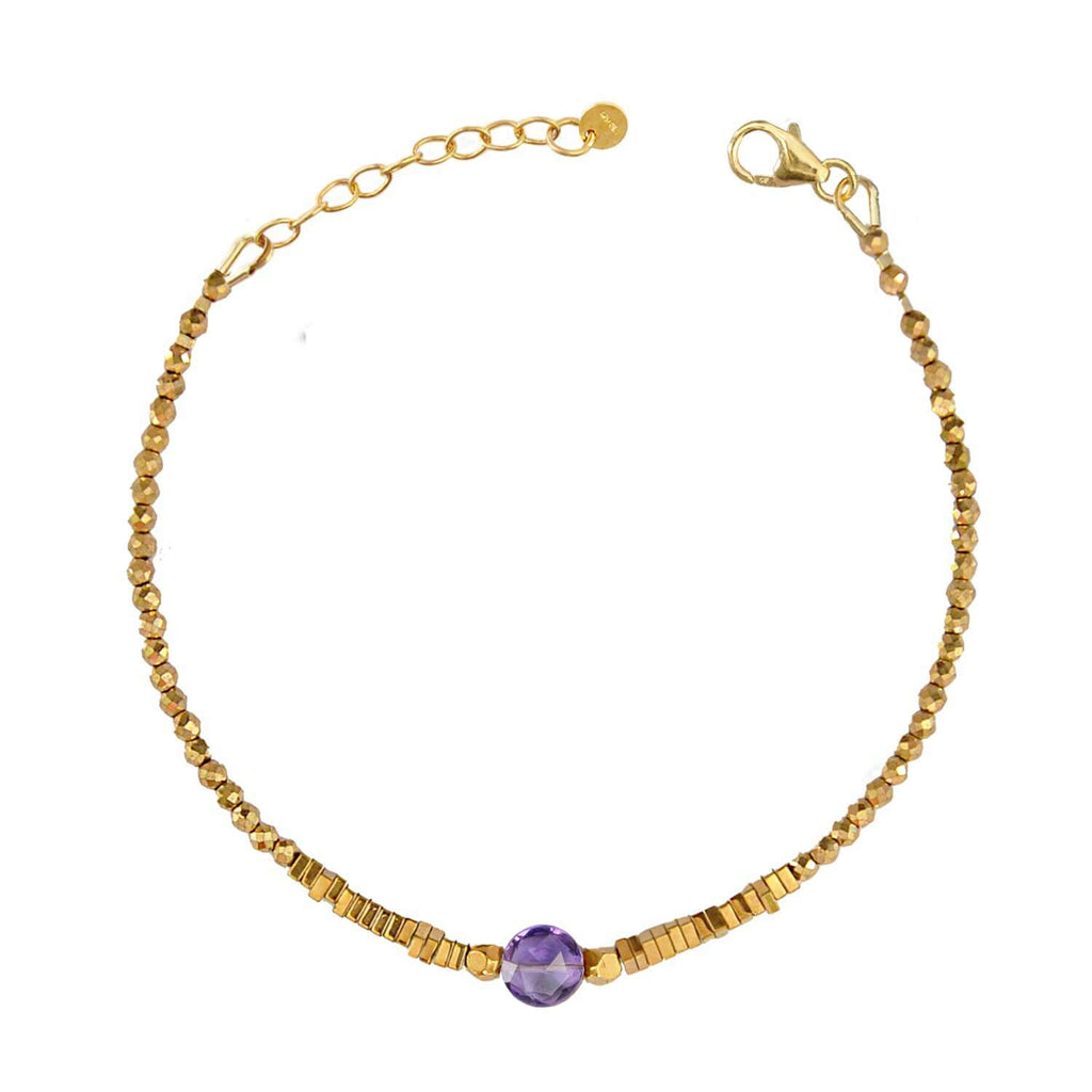 Elegant Hematite Beaded bracelet with a central faceted amethyst gemstone on a white background. Perle de Lune jewelry