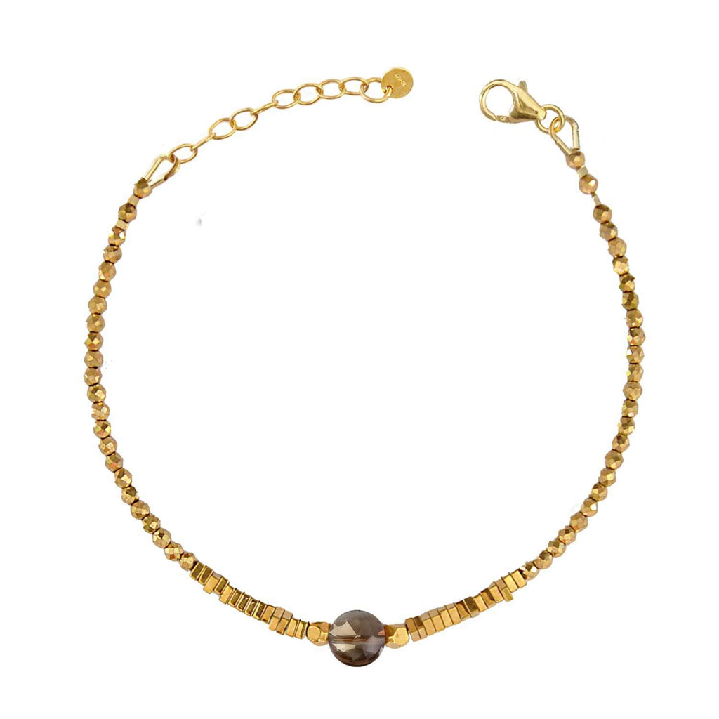 Elegant Hematite Beaded bracelet with a central faceted dark smoky quartz gemstone on a white background. Perle de Lune jewelry