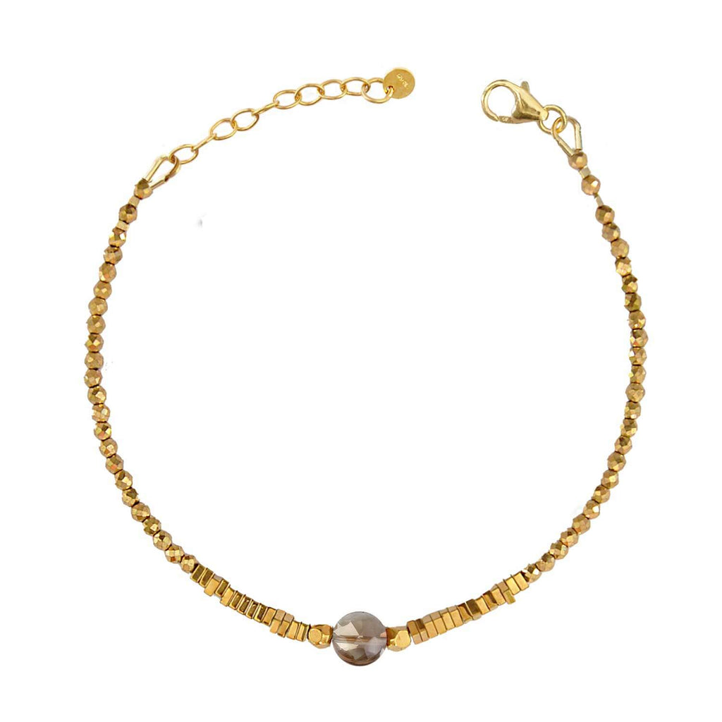 Elegant Hematite Beaded bracelet with a central faceted smoky quartz gemstone on a white background. Perle de Lune jewelry