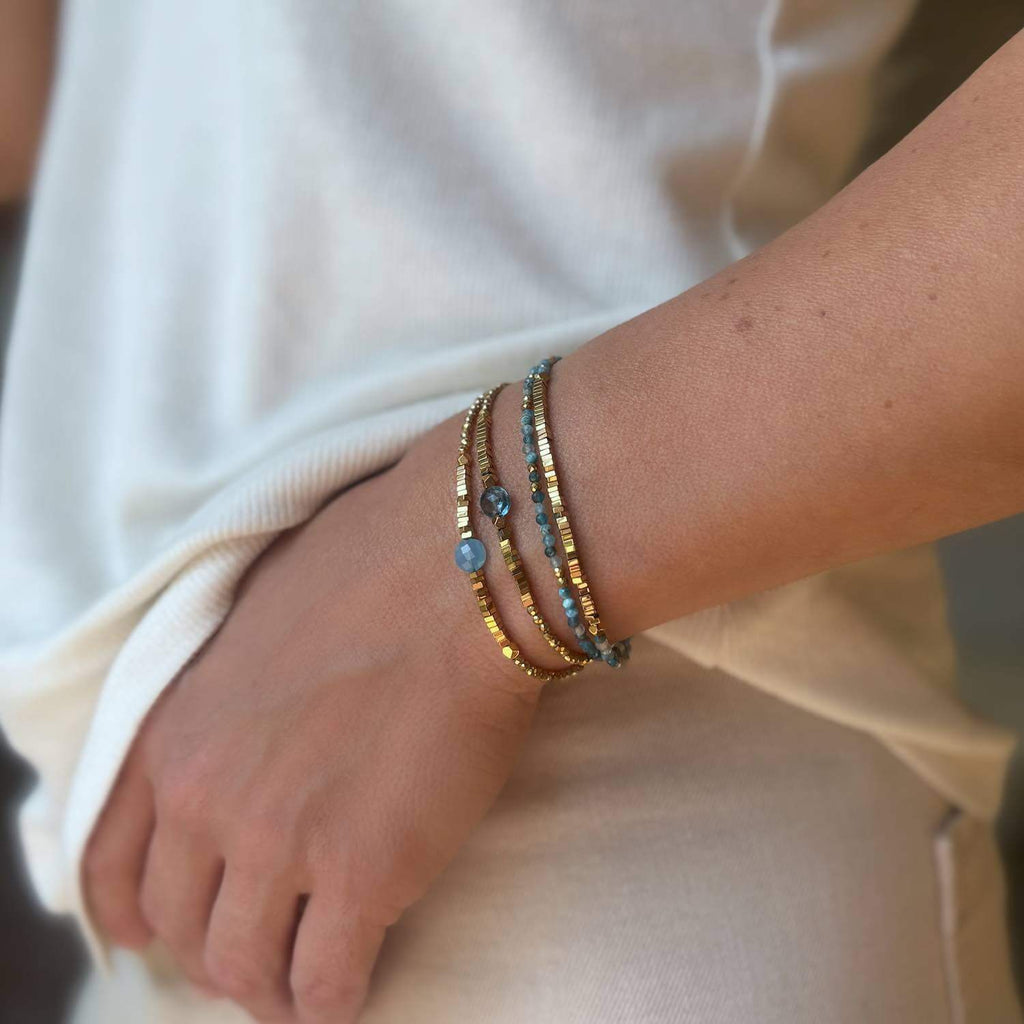 3  blue Topaz and Blue Quartz and  golden Hematite gemstone Bracelets on a model wrist
