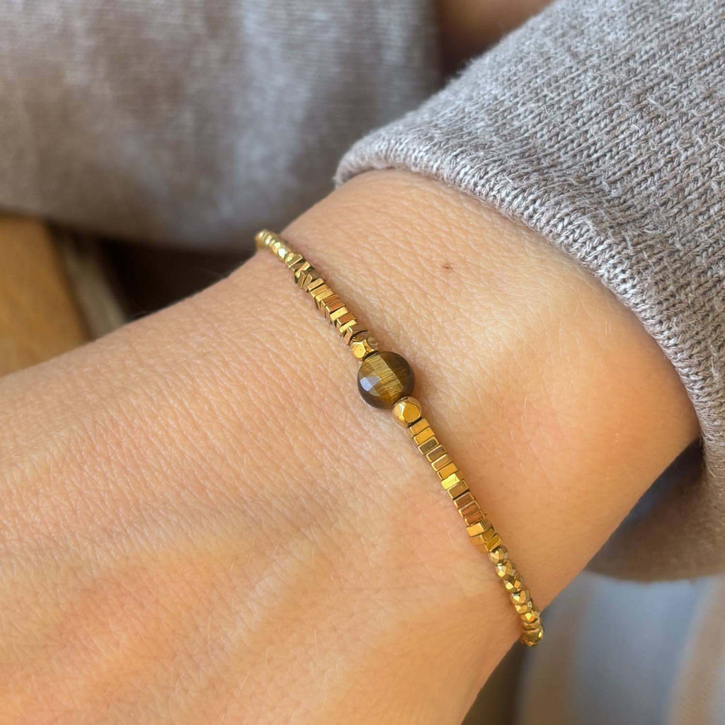 Close-up of a beaded bracelet with Tiger's eye and golden Hematite gemstones