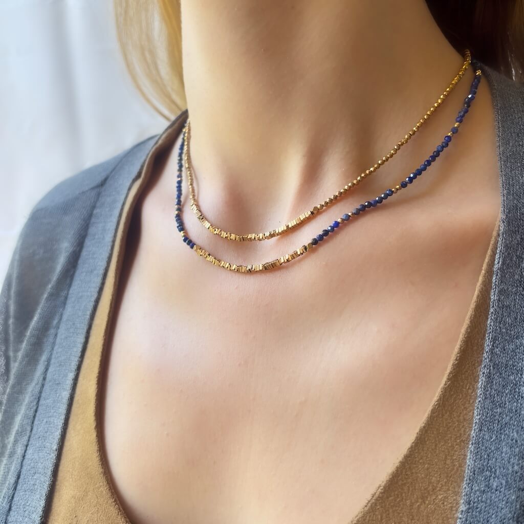 Lapis Lazuli Sunburst Bar Choker Necklace – gold Hematite on a model's neck worn with the plain hematite choker necklace