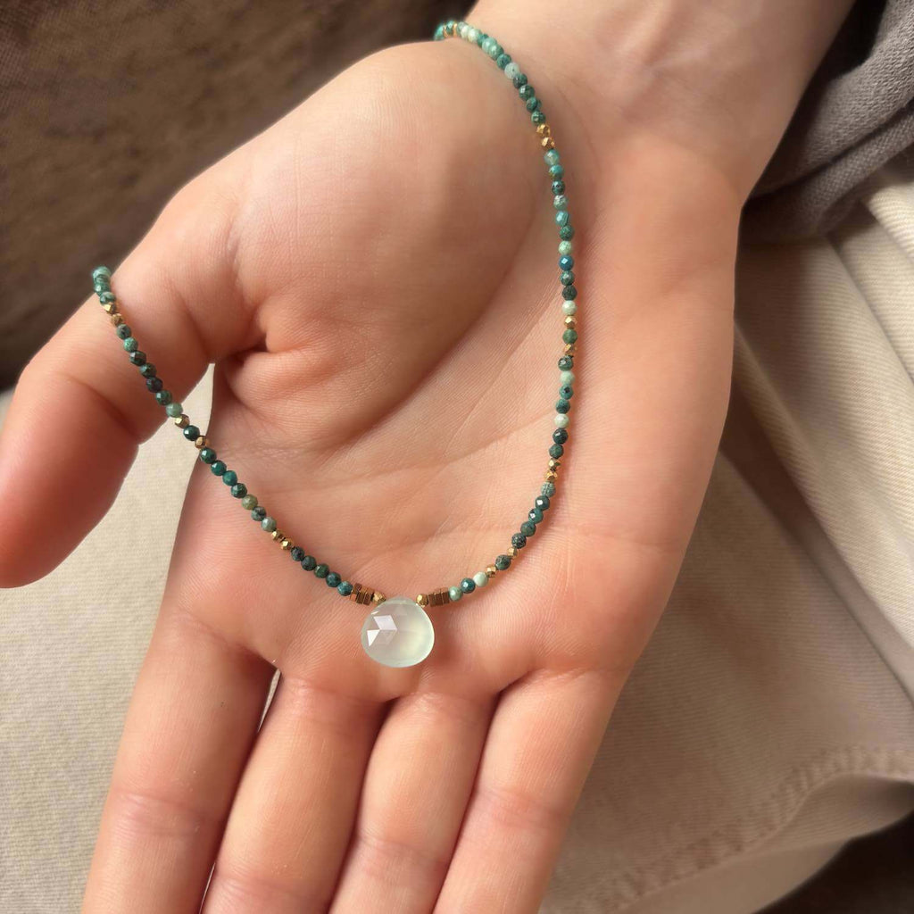 Choker Necklace with green Chalcedony Drop  central pendant drop and Chrysocolla gemstone beads in a model's hand