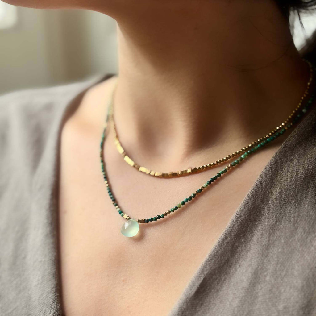 Choker Necklace with green Chalcedony Drop  central pendant drop and Chrysocolla gemstone beads on a models neck layered with a gold hematite choker