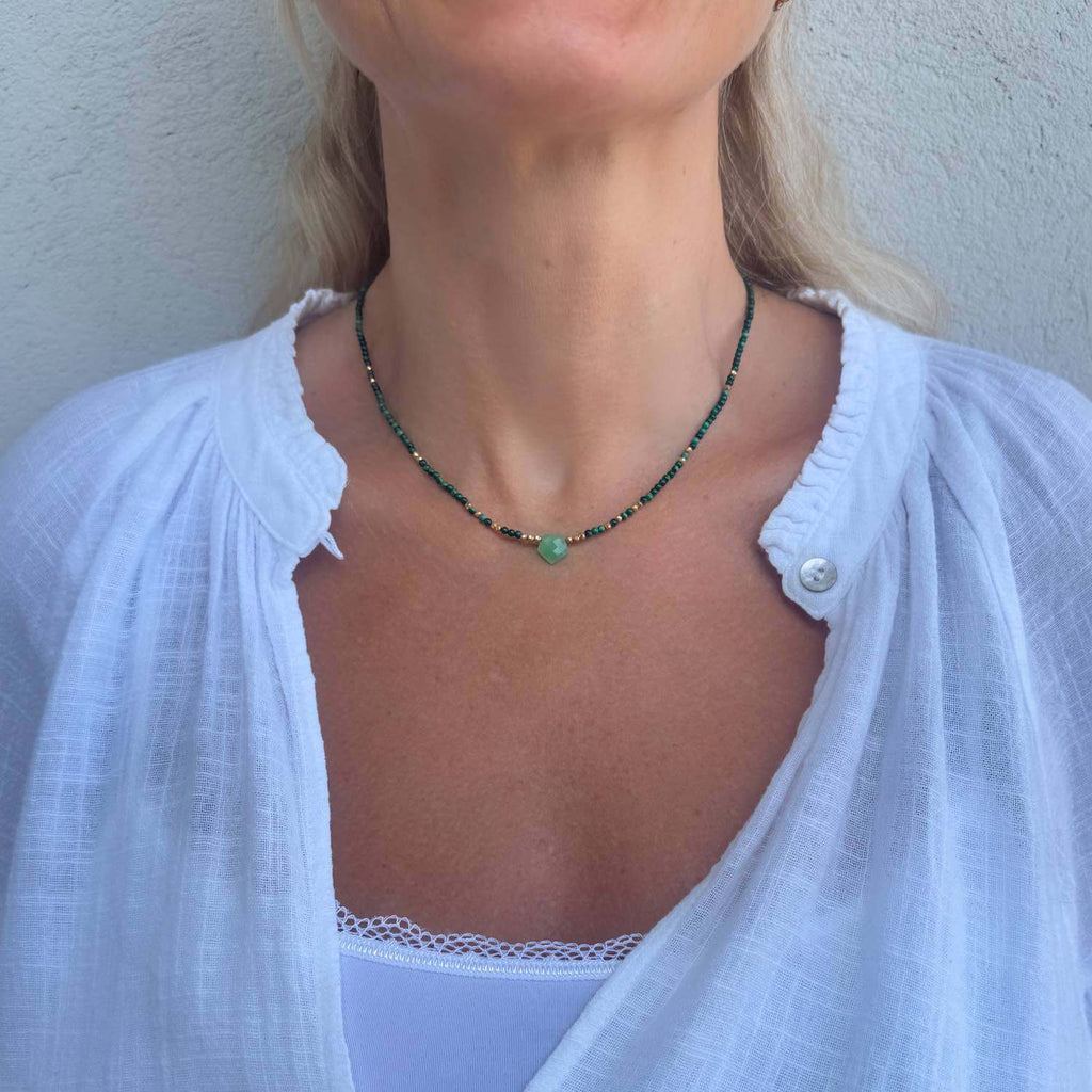 Choker necklace with Chrysoprase bullet gemstone and Malachite beads on a model wearing a white blouse