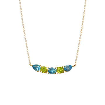 A luminous and unique 18k gold choker necklace with a central curved bar pattern of Swiss Blue Topaz and Peridot set on claws. Spectacular and easy to wear.