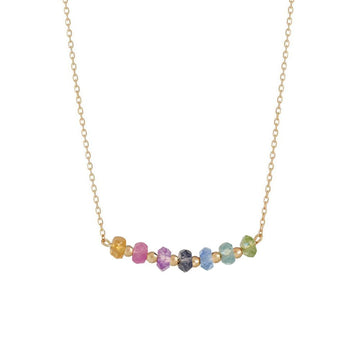 rainbow bar necklace in 18k gold with hessonite garnet, pink sapphire, amethyst, iolite, blue topaz, apatite and peridot gemstones.