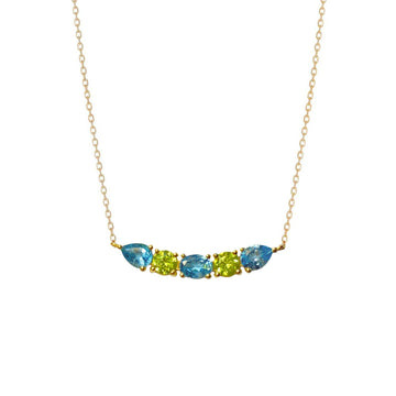 A luminous and unique 18k gold choker necklace with a central curved bar pattern of Swiss Blue Topaz and Peridot set on claws. Spectacular and easy to wear.