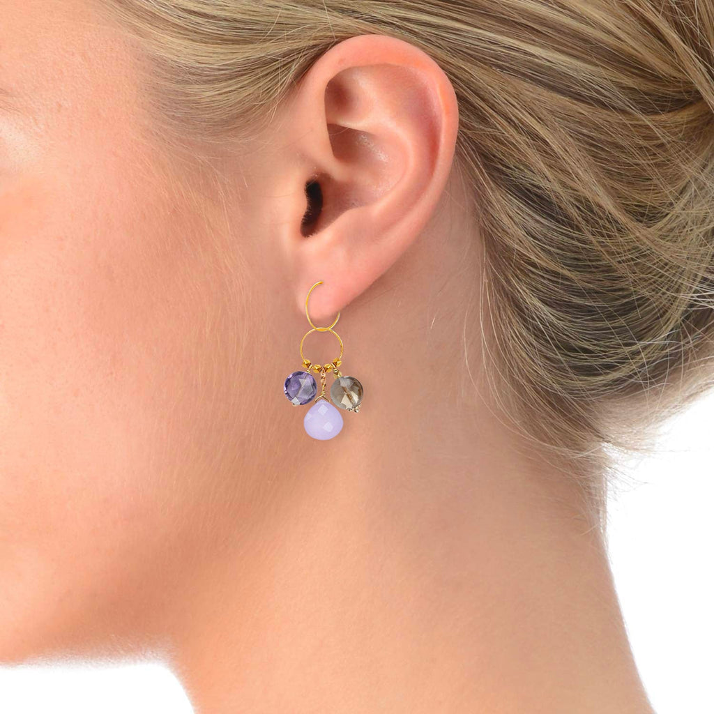 A trio of gemstone charms in 18k gold on a model ear  with  Amethyst, Lavender Jade & Smoky Quartz 