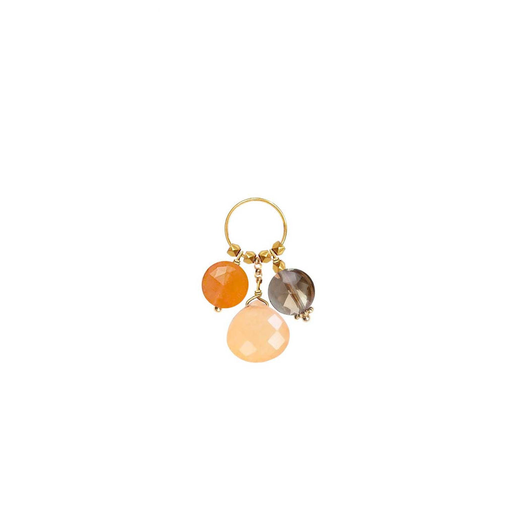 A trio of gemstone charms hanging from a ring in 18k gold with Carnelian, Orange Jade and  Smoky Quartz