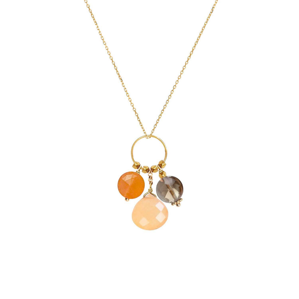 A trio of gemstone charms hanging from a ring in 18k gold with Carnelian, Orange Jade and  Smoky Quartz