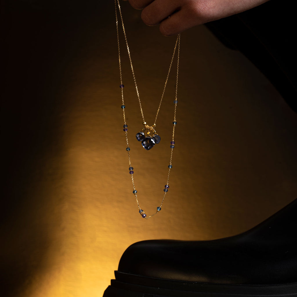 Iolite gemstones necklaces 18k gold near a boot - Perle de Lune